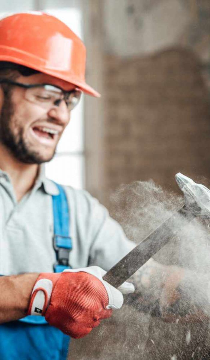 contractor-working-very-hard-strikes-with-a-hammer-3A5VUDF.jpg